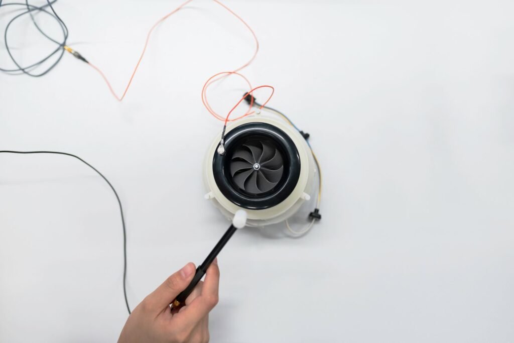 Small fan motor connected for testing